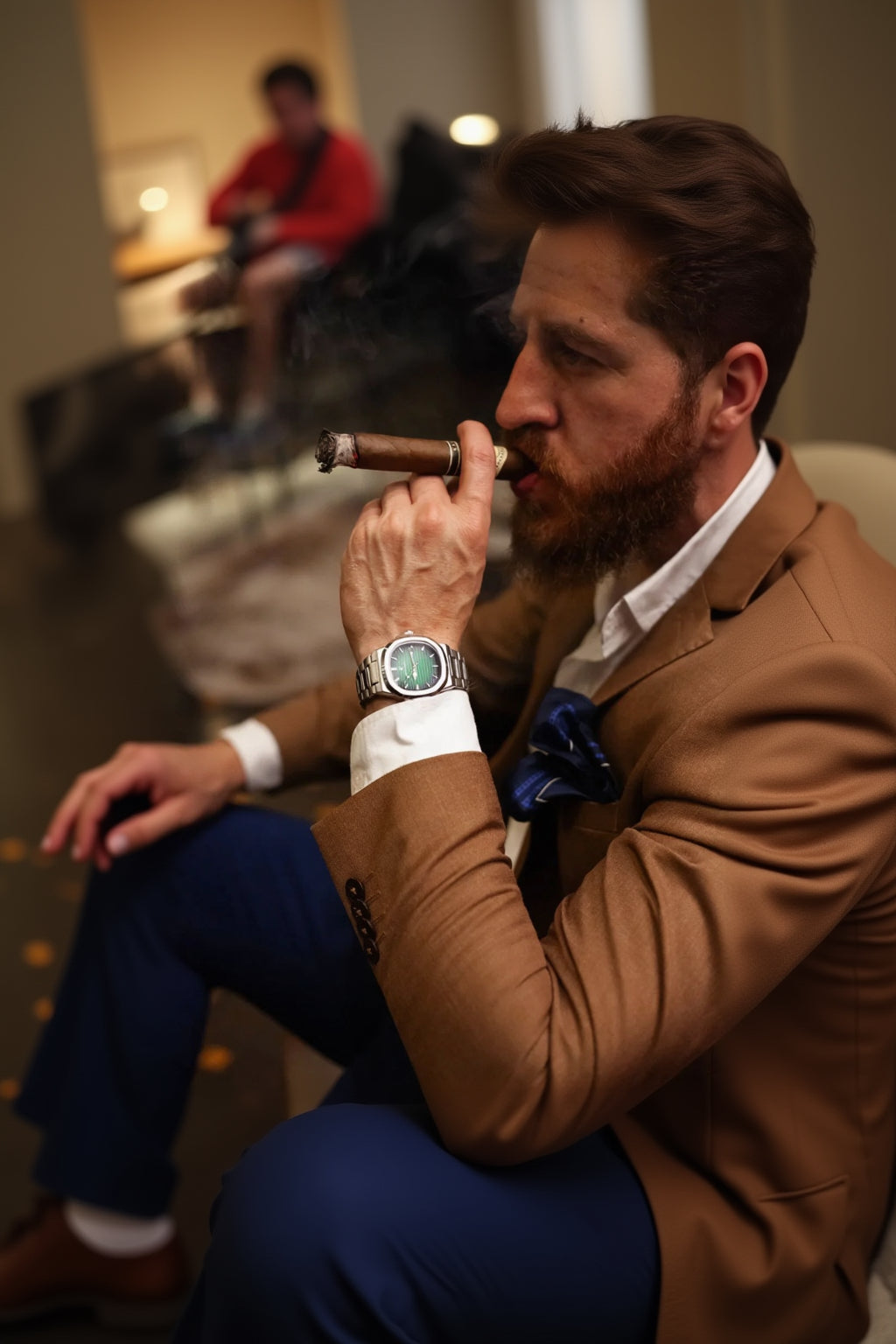 Man in a brown suit smoking a cigar with a Montvail Marinor watch on his wrist.