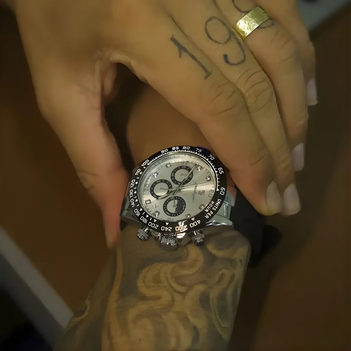 Hand with tattoo wearing a watch, close-up