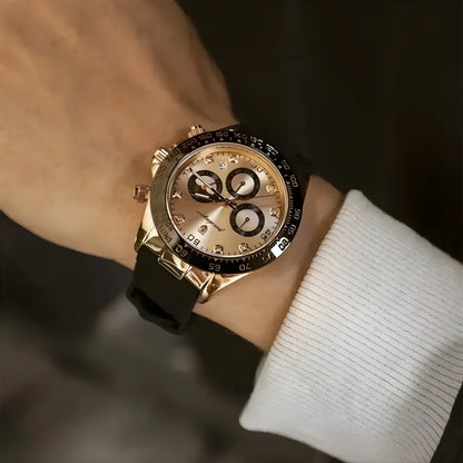 Gold wristwatch with black strap on a wrist, blurred background