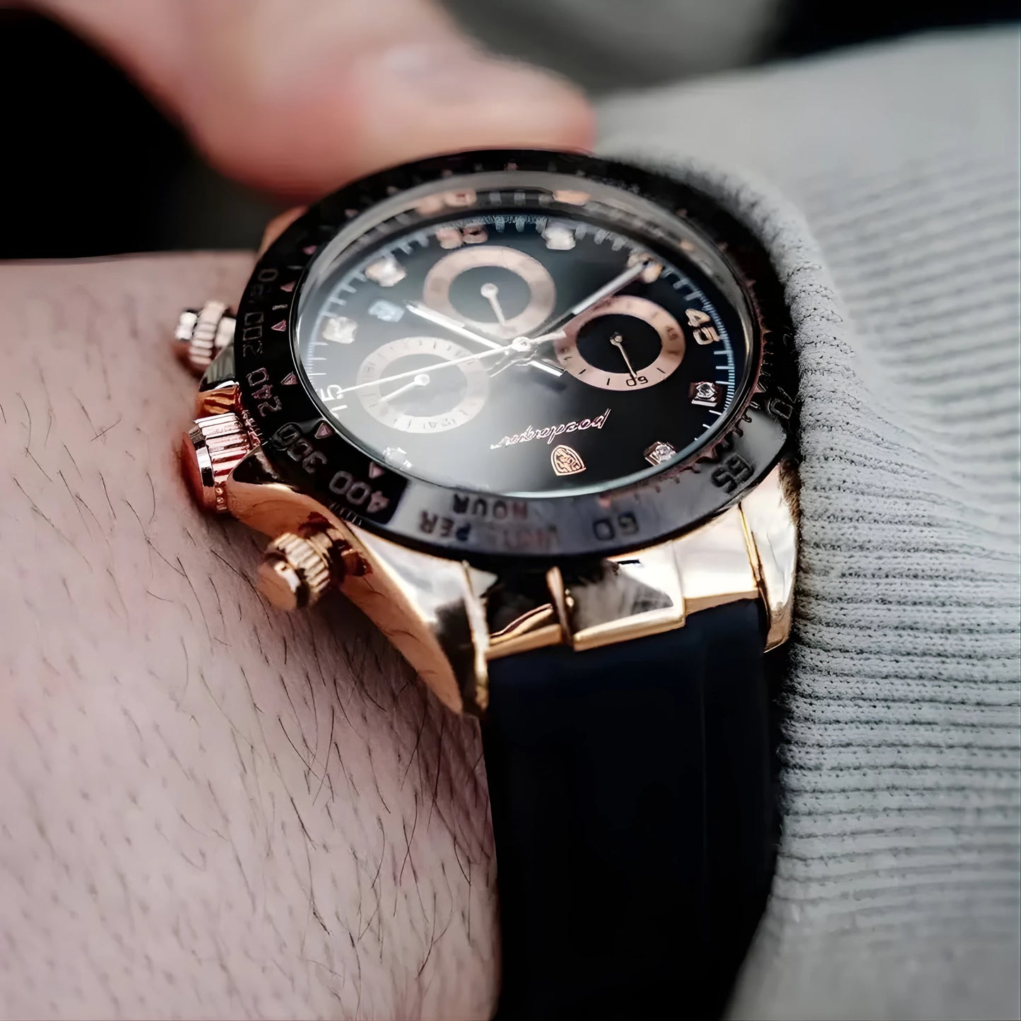 Luxury watch with black face and rose gold case on a wrist