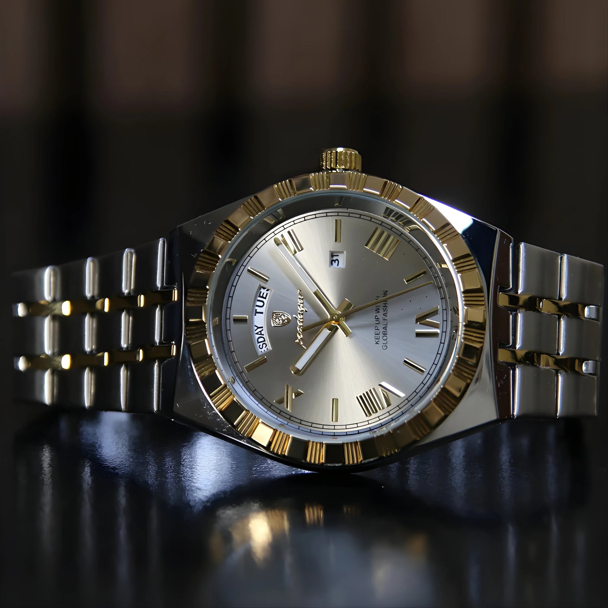 Silver and gold watch with a dark background
