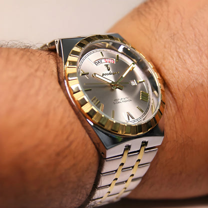 Gold and silver watch on a wrist with a blurred background