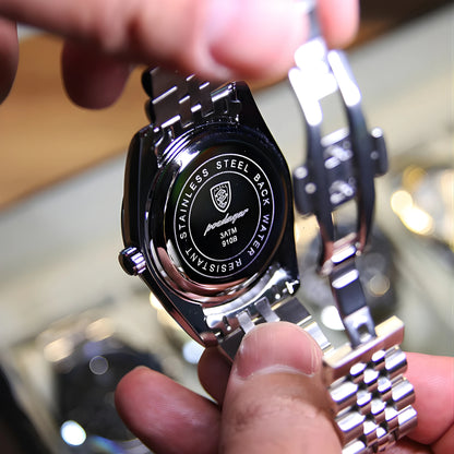 Close-up of a person holding a luxury watch with visible brand logo.