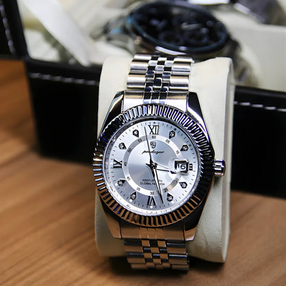 Silver wristwatch with a detailed face on a wooden surface