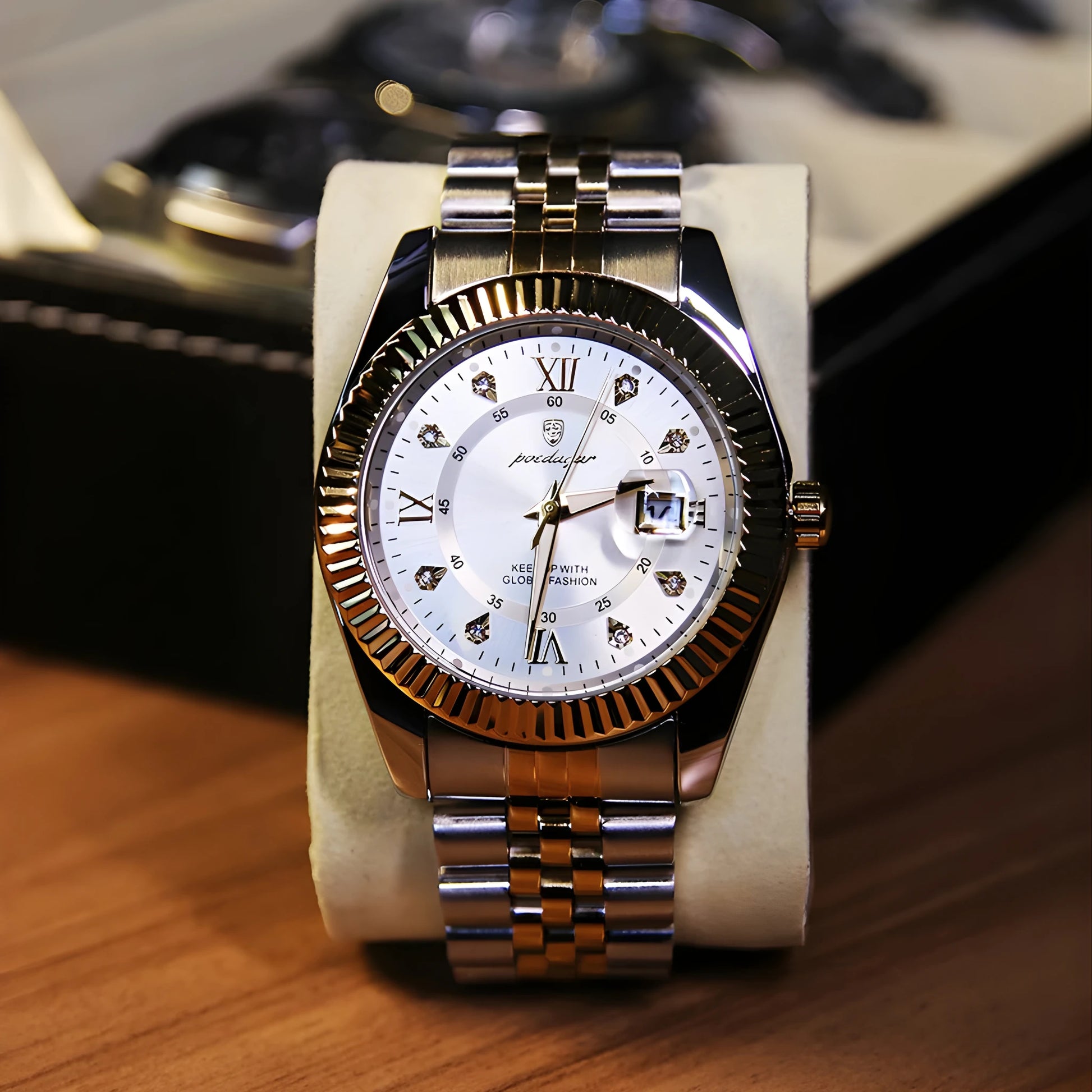 Luxury watch with a silver and gold band on a wooden surface