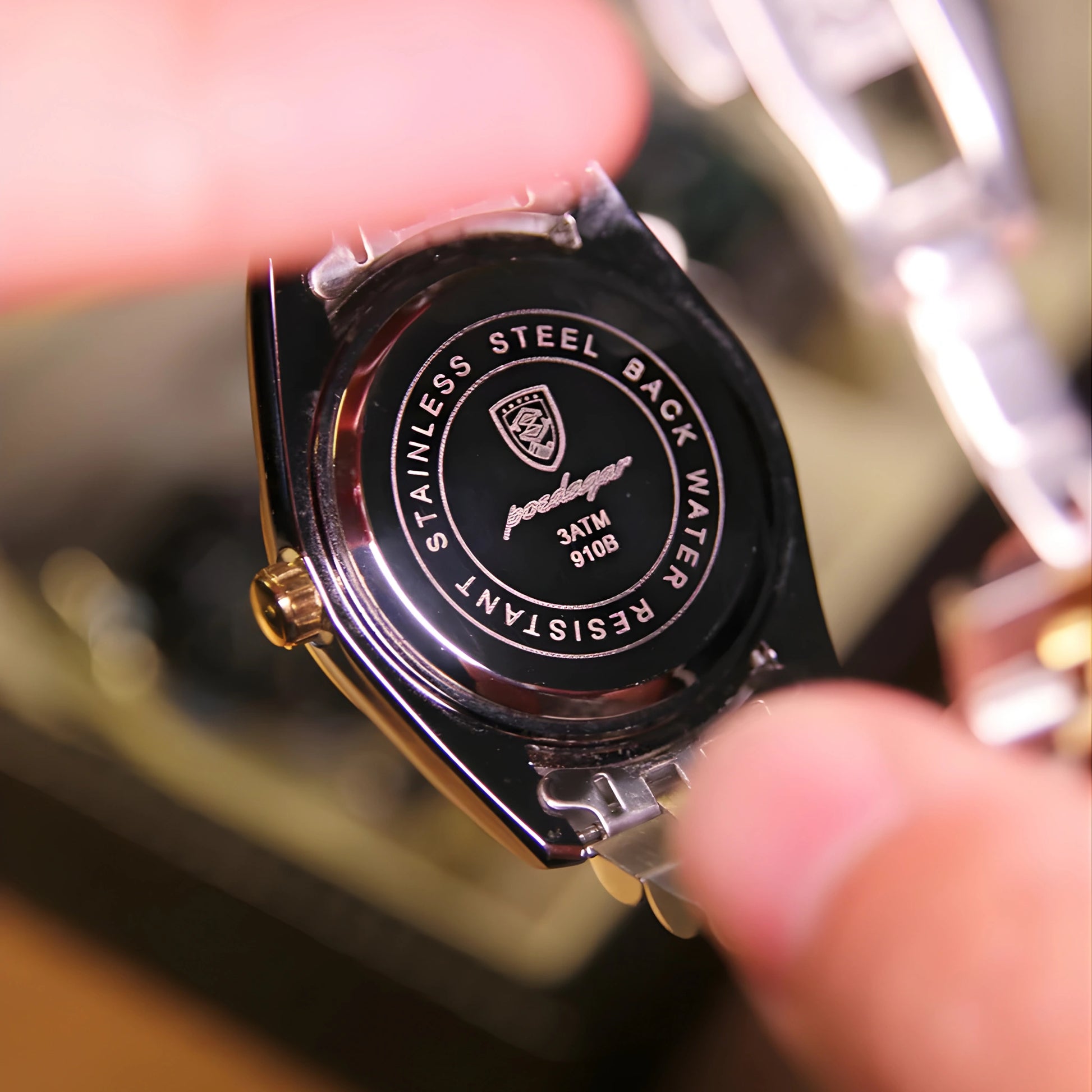 Close-up of a watch case with 'Pandong' branding, held by a hand.