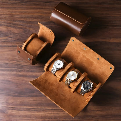 Brown leather watch case with four watches on a wooden surface